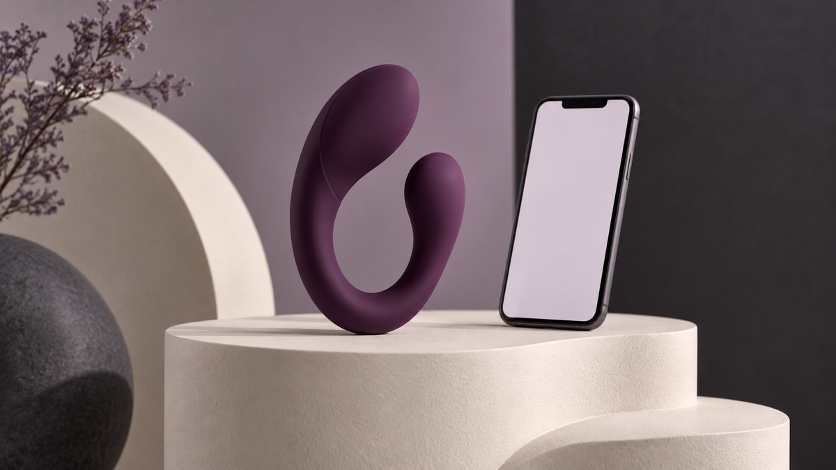 Illustrative dual-arm wellness-device concept beside a phone, not an exact product model