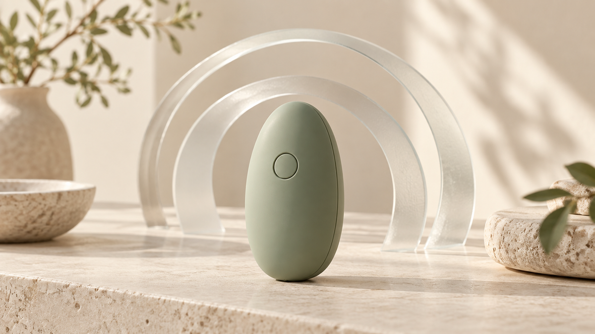 Illustrative oval device with abstract glass acoustic arcs; not a measured noise claim