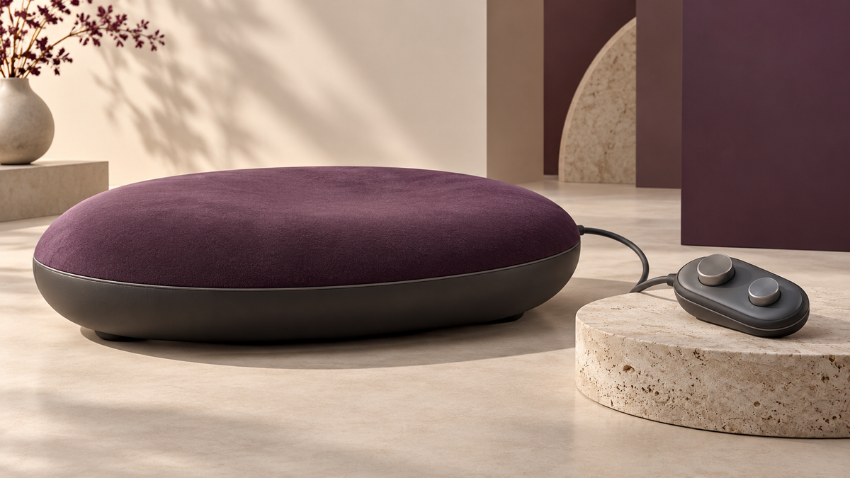Conceptual seated wellness-device form with separate controller; not a Sybian product photograph