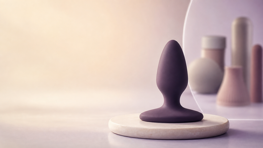Purpose-made butt plug with a wide flared base shown in a safety-first editorial scene