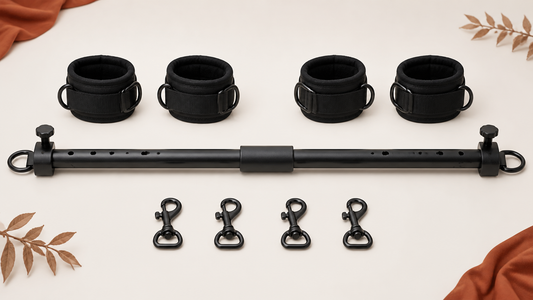 Adjustable spreader bar with padded cuffs and connector clips arranged for inspection