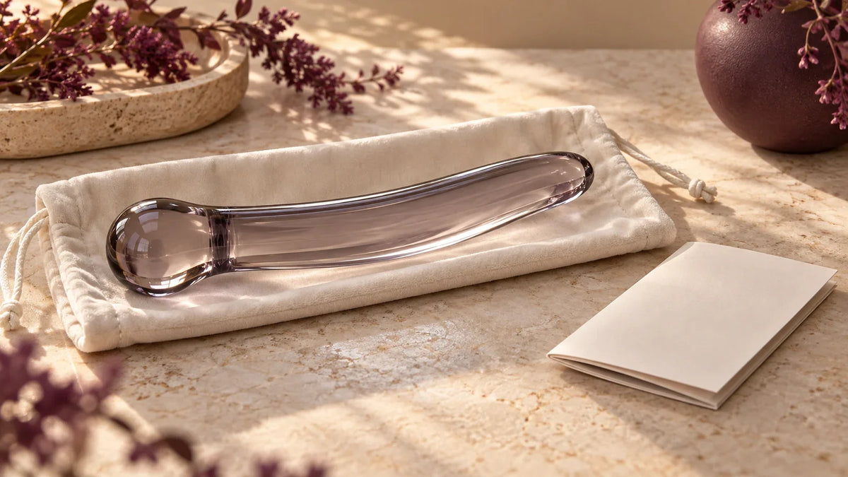 Generic rounded glass wellness device in a padded pouch beside a blank manual; illustrative concept, not a listed product
