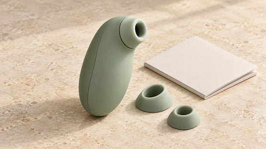Generic external air-pulse wellness device with separate soft contact heads on a neutral surface; not a Womanizer product photograph