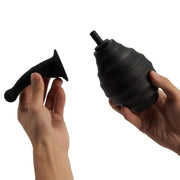 Detachable curved nozzle and black ribbed squeeze bulb after rinsing